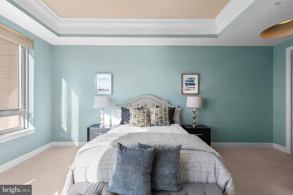 a bedroom with a bed and a large window