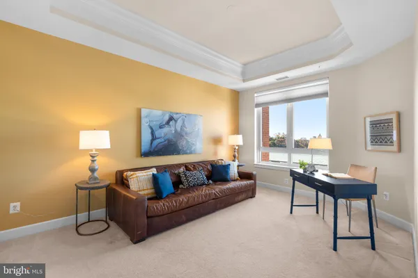 a living room with furniture and a lamp