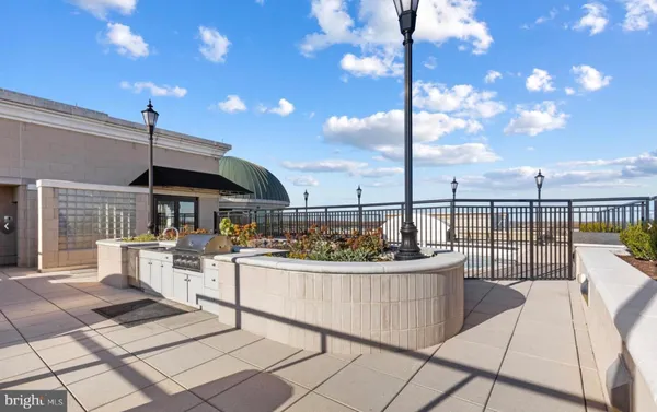 a view of a roof deck with a table and chairs