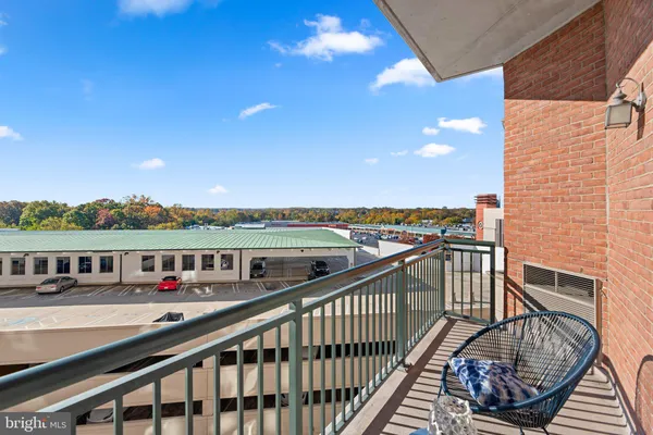 a view of a balcony with chair and barbeque grill