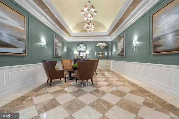 a view of a dining room with furniture and a chandelier