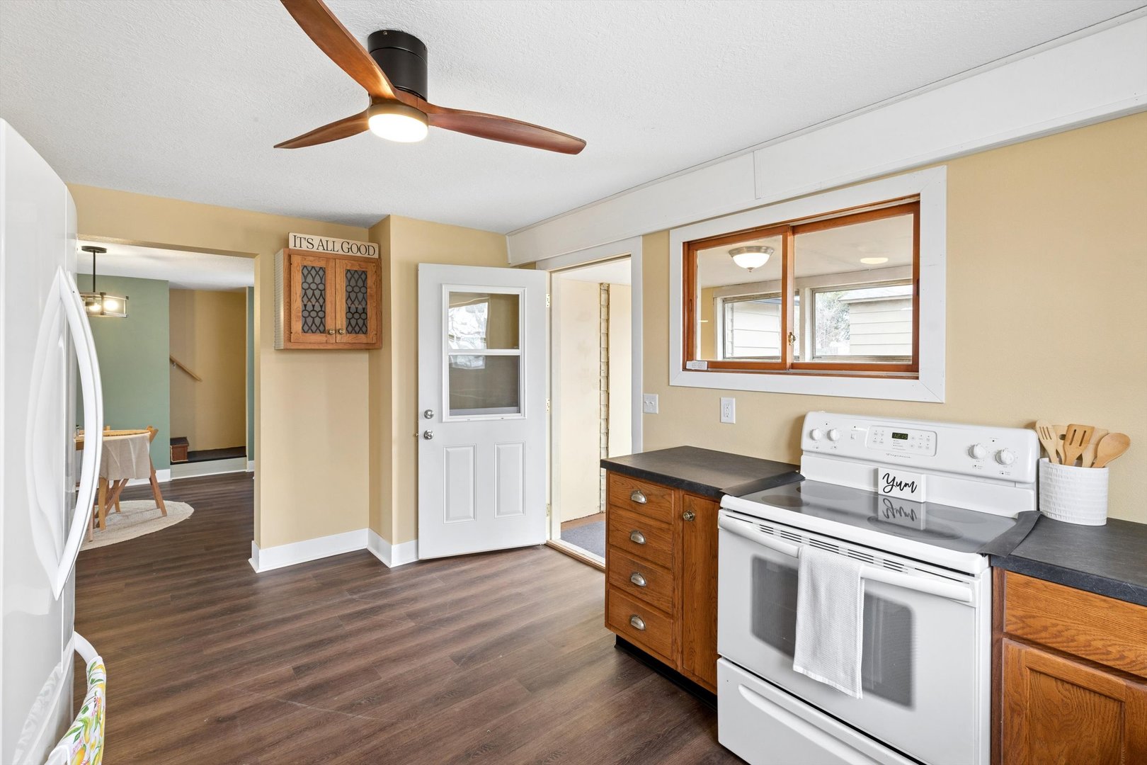 211 Clay Street New Boston, IL 61272 - Photo 11 of 29 a kitchen with stainless steel appliances wooden floors and white cabinets
