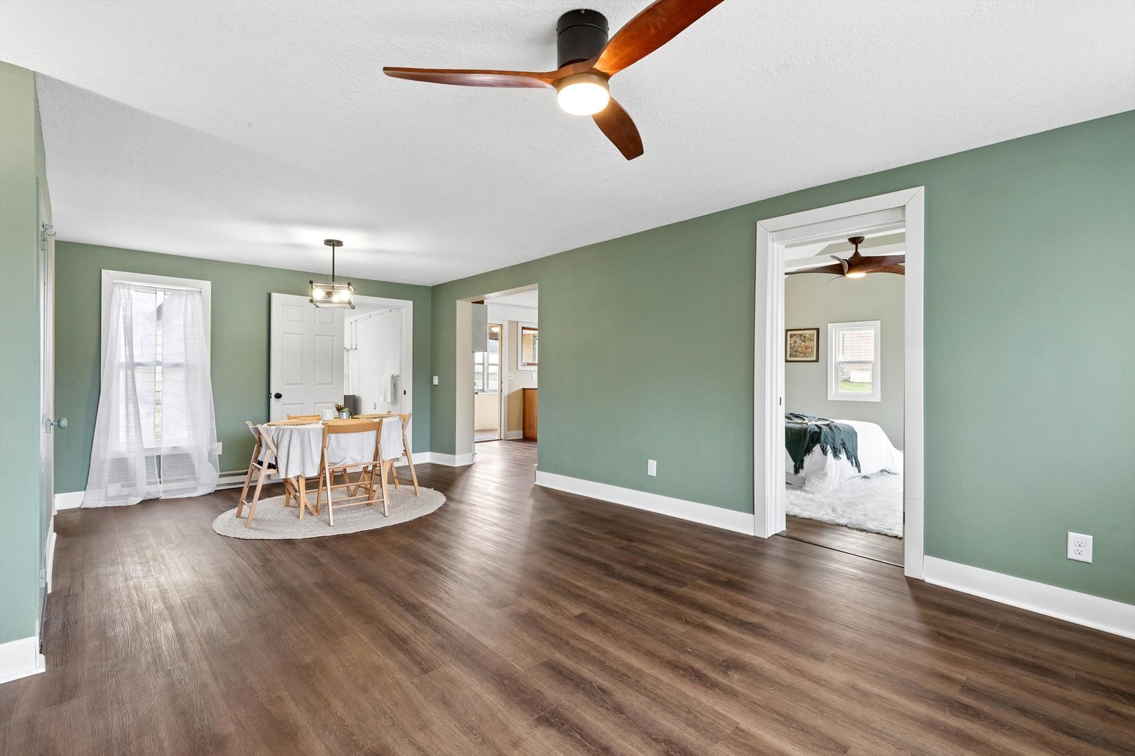 211 Clay Street New Boston, IL 61272 - Photo 5 of 29 a dining room with wooden floor and chandelier
