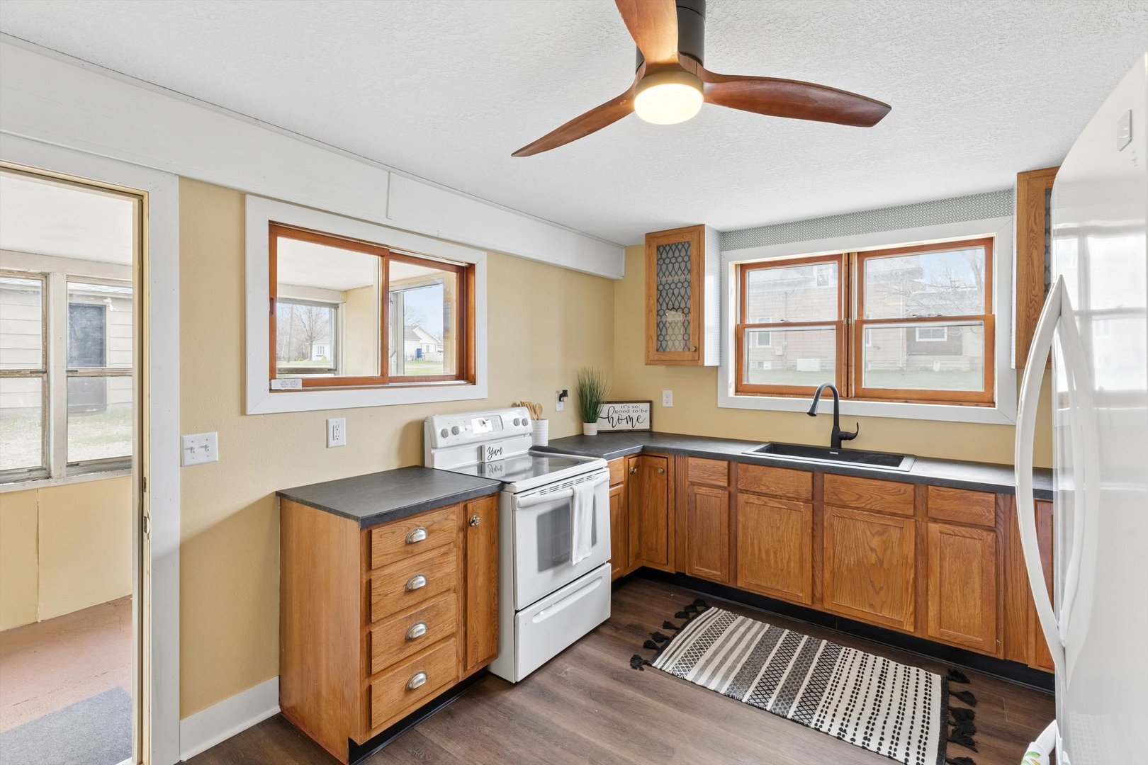 211 Clay Street New Boston, IL 61272 - Photo 10 of 29 a kitchen with stainless steel appliances granite countertop a sink a stove cabinets and wooden floor