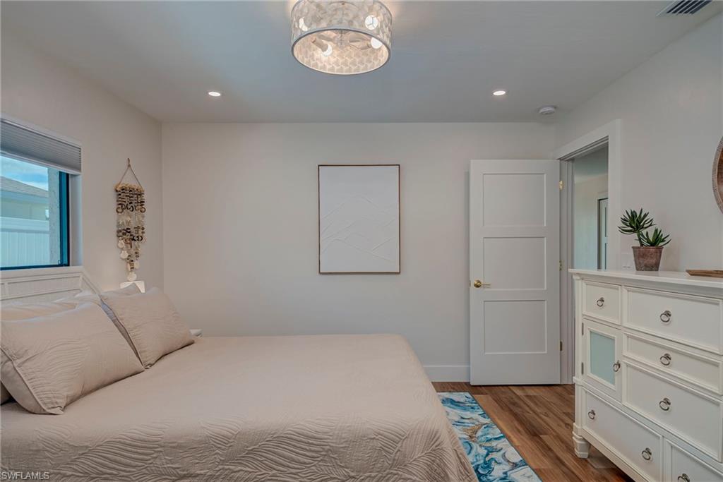 577 98th Avenue North Naples, FL 34108 - Photo 12 of 33 a bedroom with a bed and cabinets