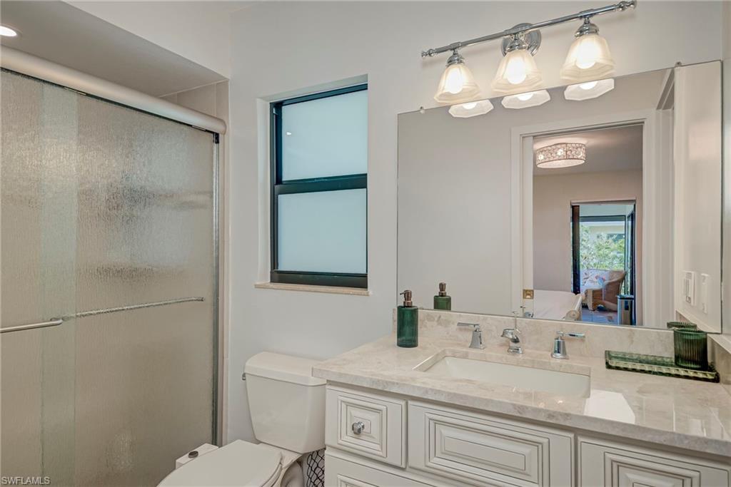 577 98th Avenue North Naples, FL 34108 - Photo 17 of 33 a bathroom with a sink a toilet and a mirror