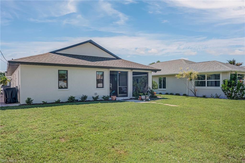 577 98th Avenue North Naples, FL 34108 - Photo 22 of 33 a front view of a house with a garden
