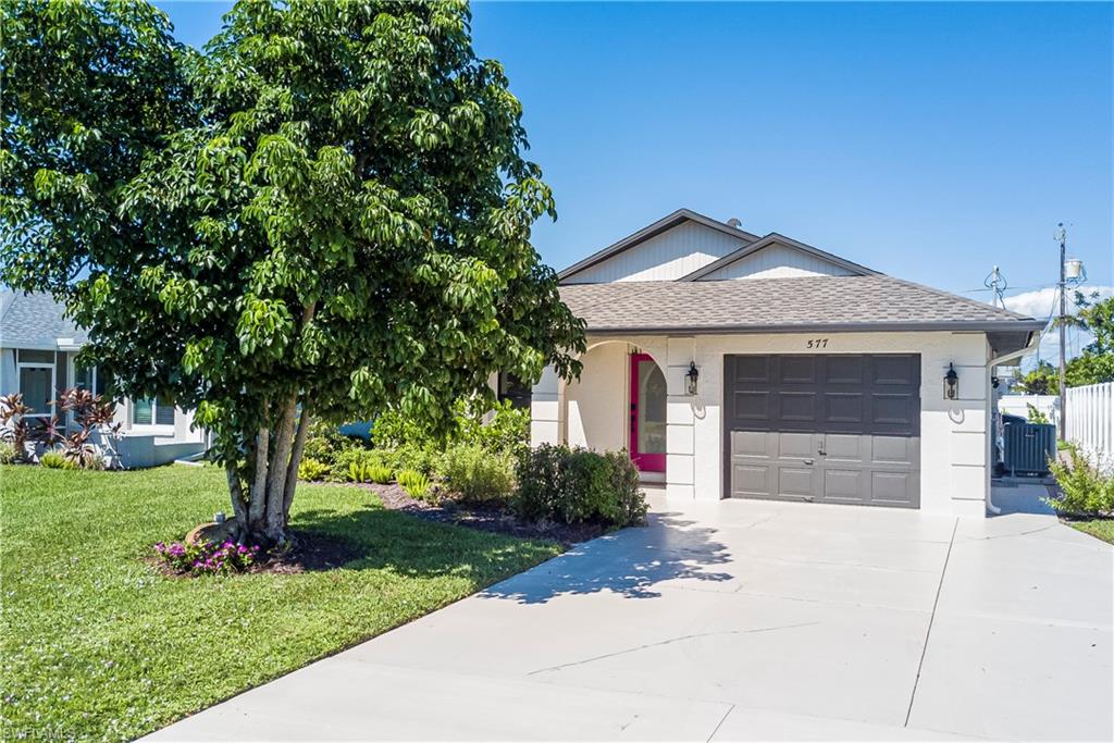 577 98th Avenue North Naples, FL 34108 - Photo 27 of 33 a front view of a house with garden