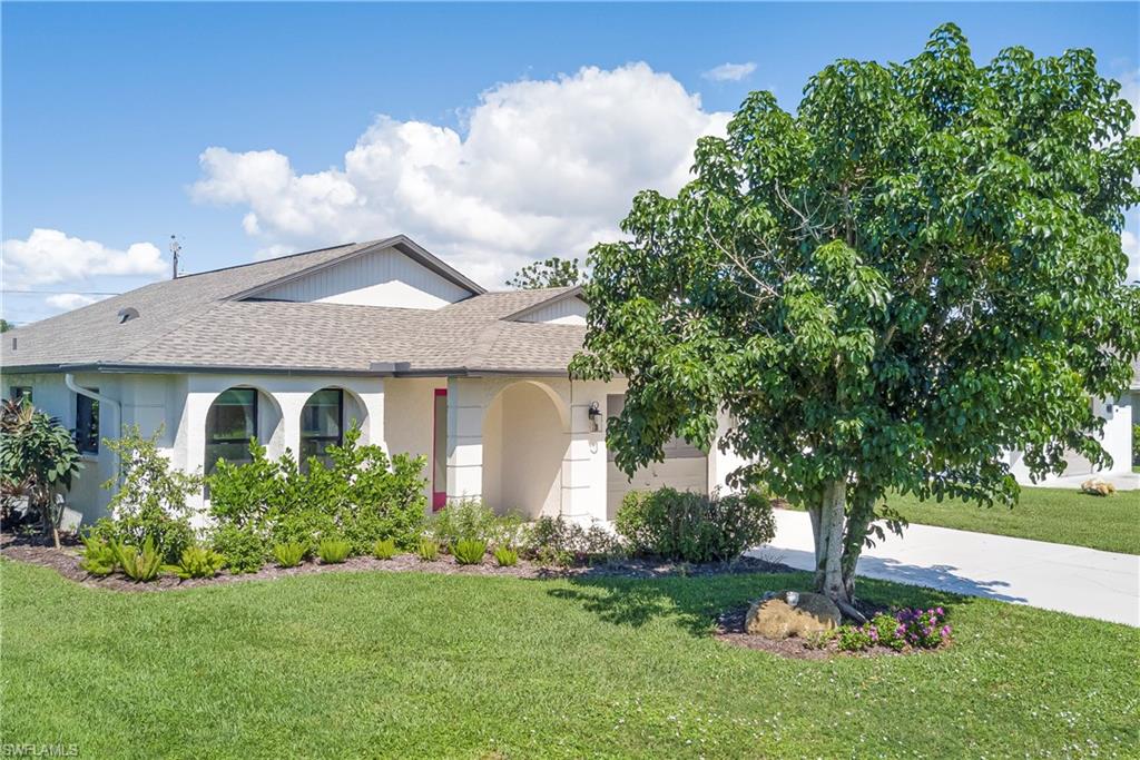 577 98th Avenue North Naples, FL 34108 - Photo 28 of 33 a front view of a house with garden