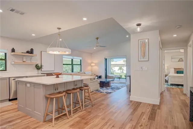 a kitchen with a table chairs refrigerator and cabinets