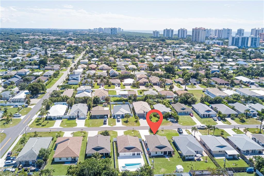 577 98th Avenue North Naples, FL 34108 - Photo 32 of 33 an aerial view of residential houses with outdoor space and parking