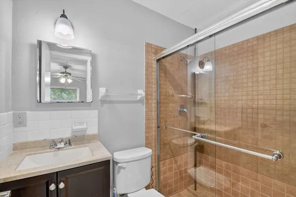 a bathroom with a sink mirror toilet and shower