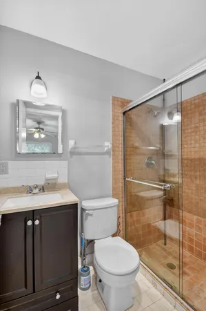 a bathroom with a sink toilet and shower