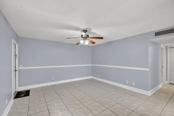 a view of a room with window and ceiling fan