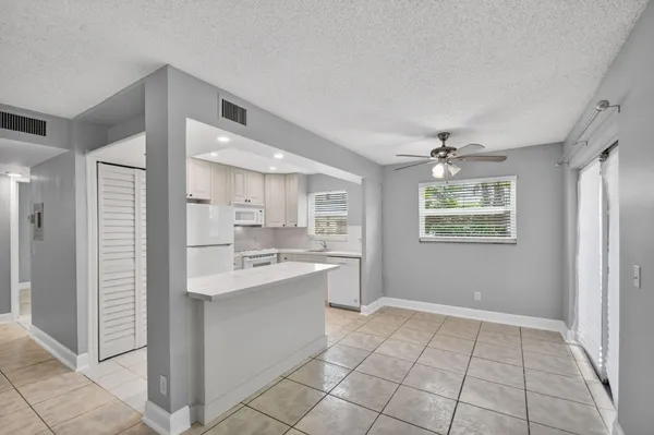 a kitchen with stainless steel appliances a sink stove and cabinets