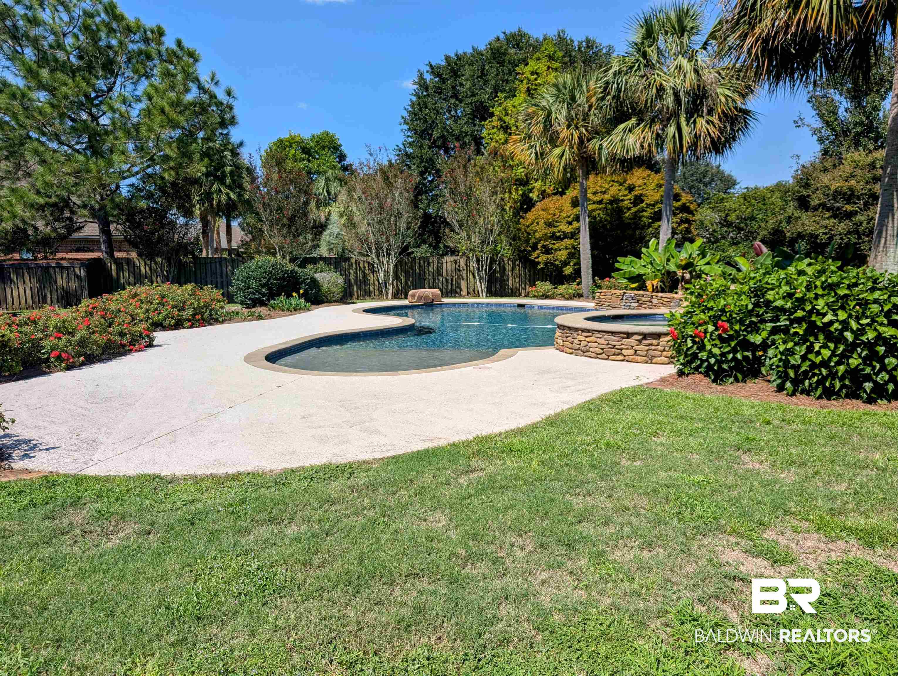 11623 Halcyon Loop Daphne, AL 36526 - Photo 88 of 90 View of swimming pool featuring a lawn and an in ground hot tub
