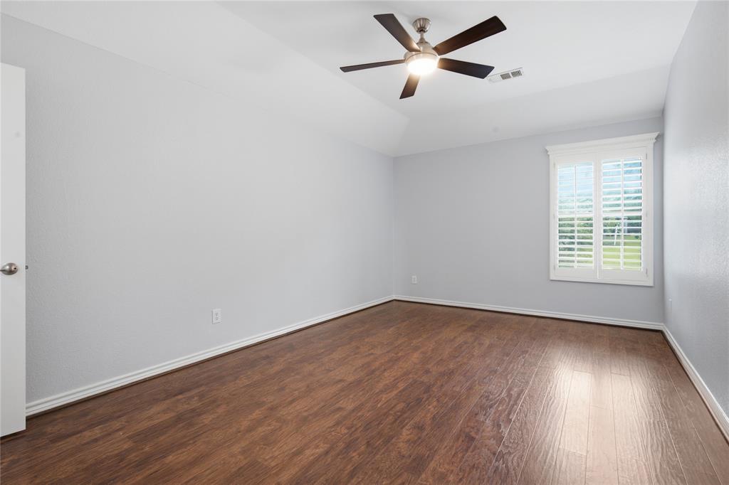 10001 Thurman Road Fort Worth, TX 76244 - Photo 22 of 40 Spacious room featuring wood-finish flooring, white baseboards, and light gray walls