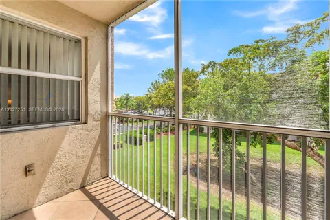 a view of a balcony with a floor to ceiling window and wooden fence