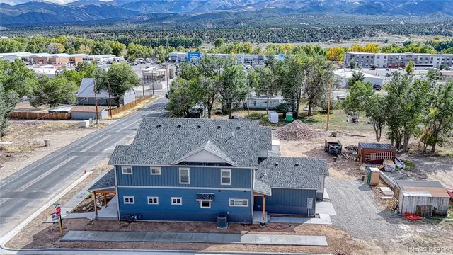 an aerial view of a house with a yard