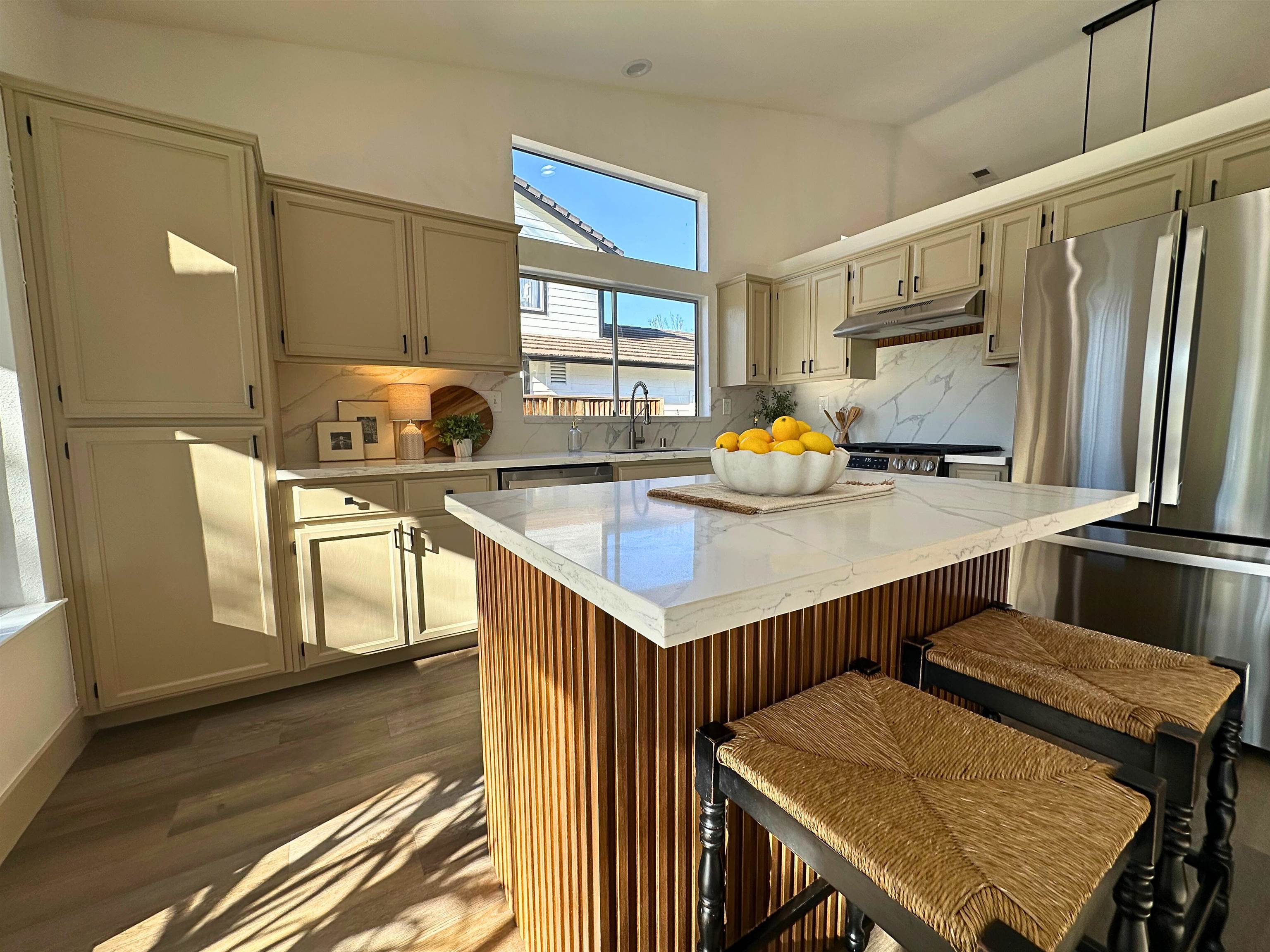 3075 Shiles Loop Brentwood, CA 94513 - Photo 11 of 37 a kitchen with stainless steel appliances a table chairs and wooden floor