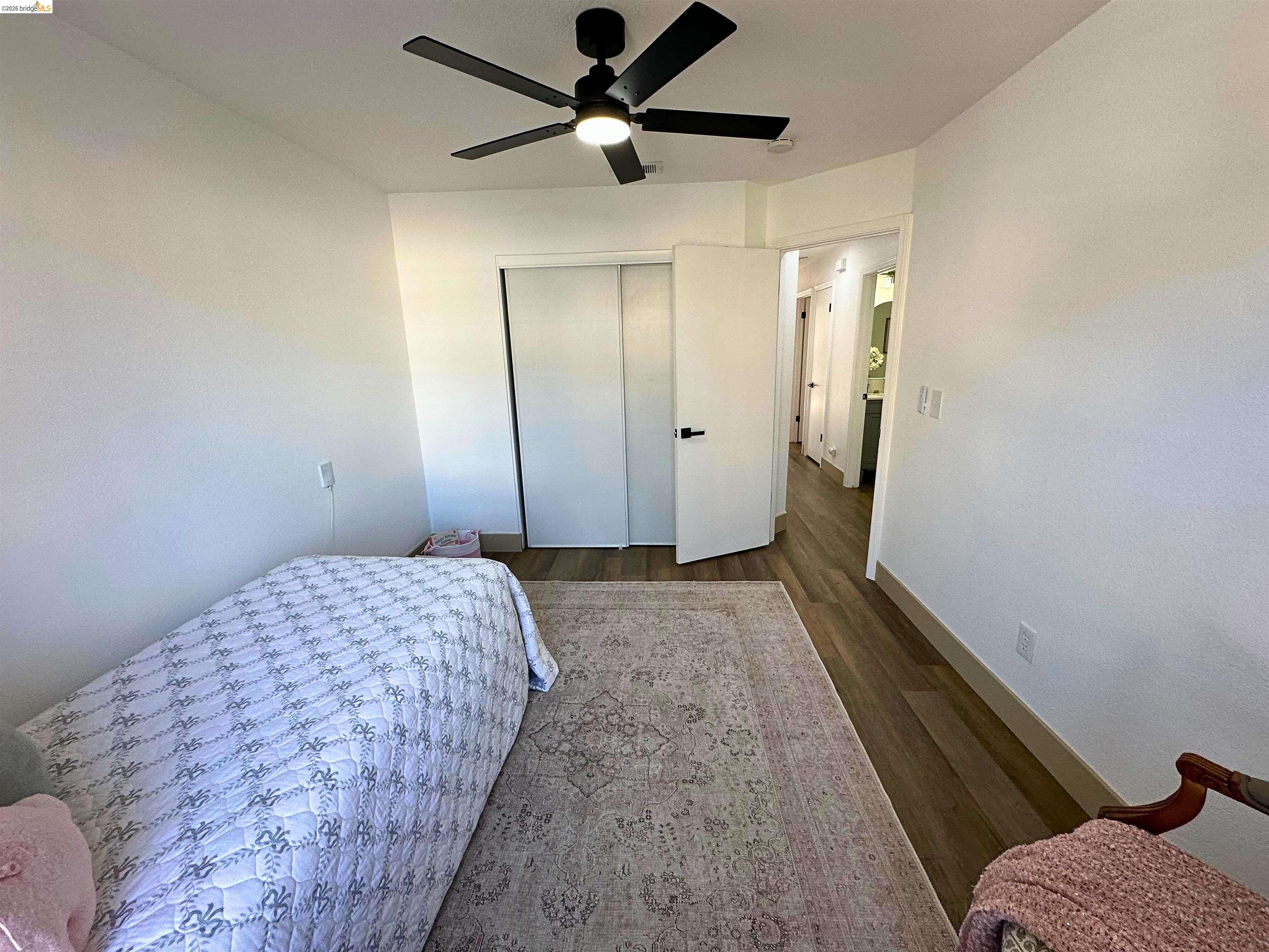 3075 Shiles Loop Brentwood, CA 94513 - Photo 13 of 37 Bedroom featuring dark wood-type flooring, a ceiling fan, and a closet