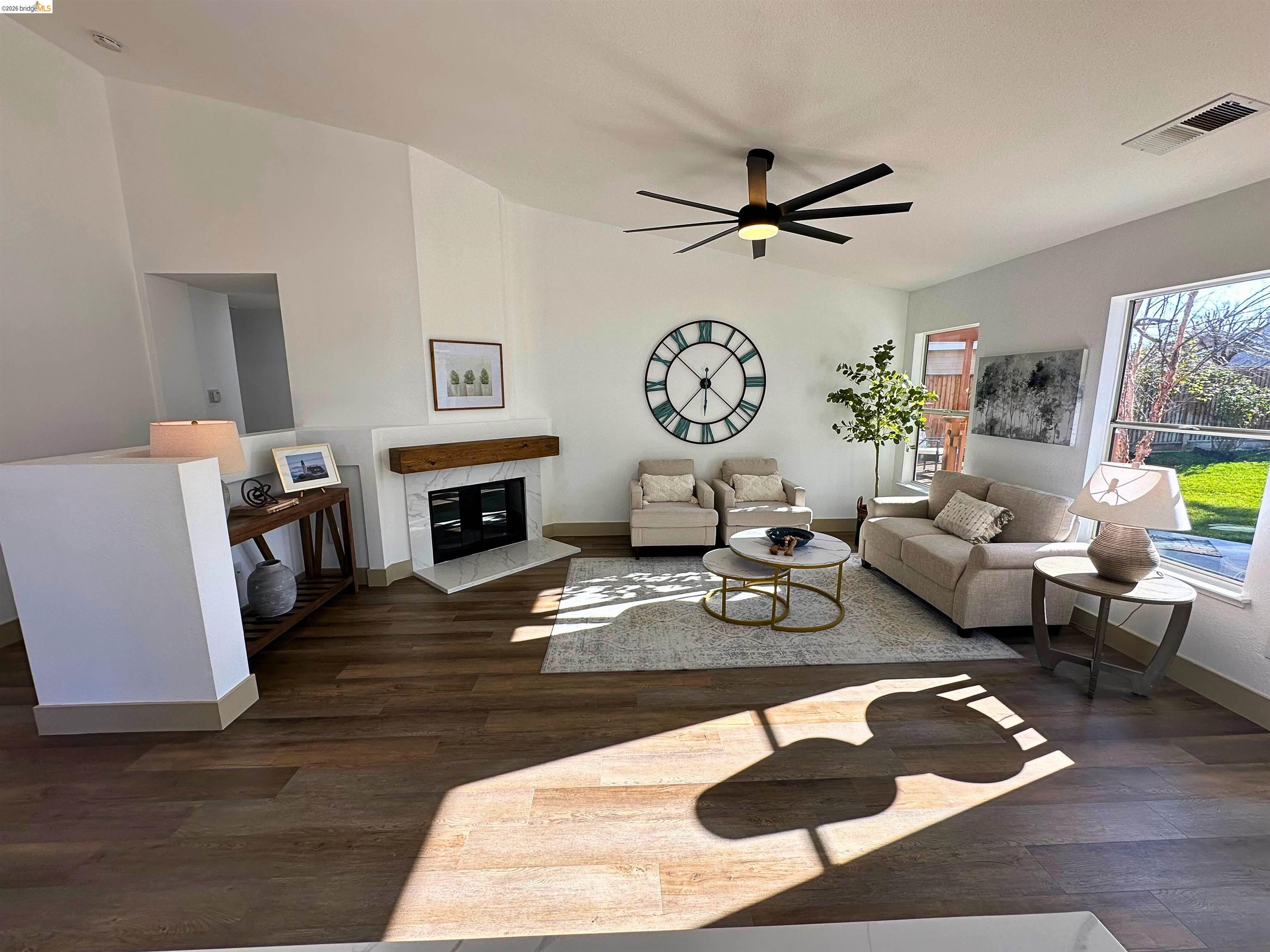 3075 Shiles Loop Brentwood, CA 94513 - Photo 20 of 37 Living room featuring a high end fireplace, dark wood finished floors, a ceiling fan, and vaulted ceiling