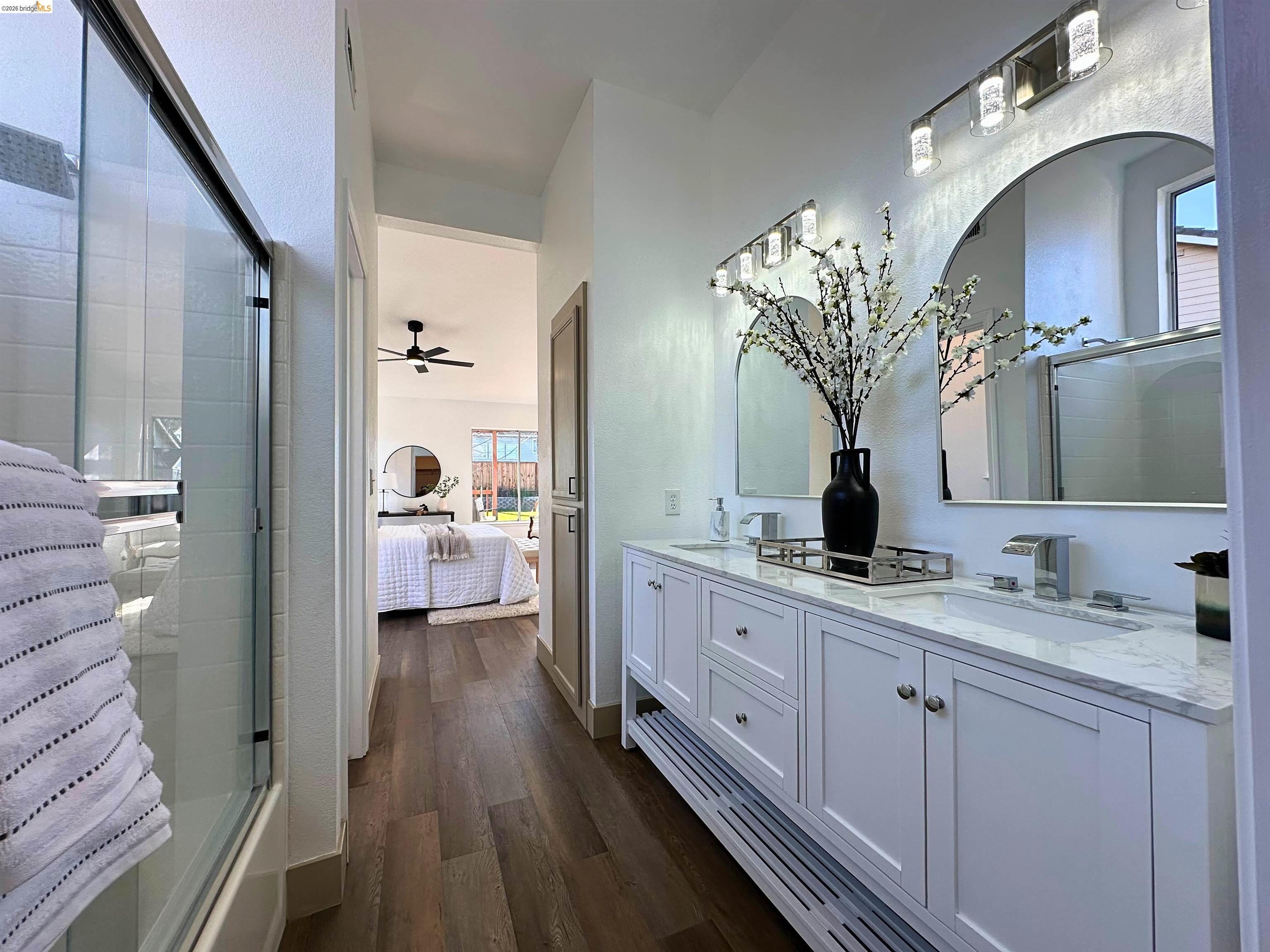 3075 Shiles Loop Brentwood, CA 94513 - Photo 6 of 37 Full bath with ensuite bath, double vanity, dark wood-style flooring, and ceiling fan