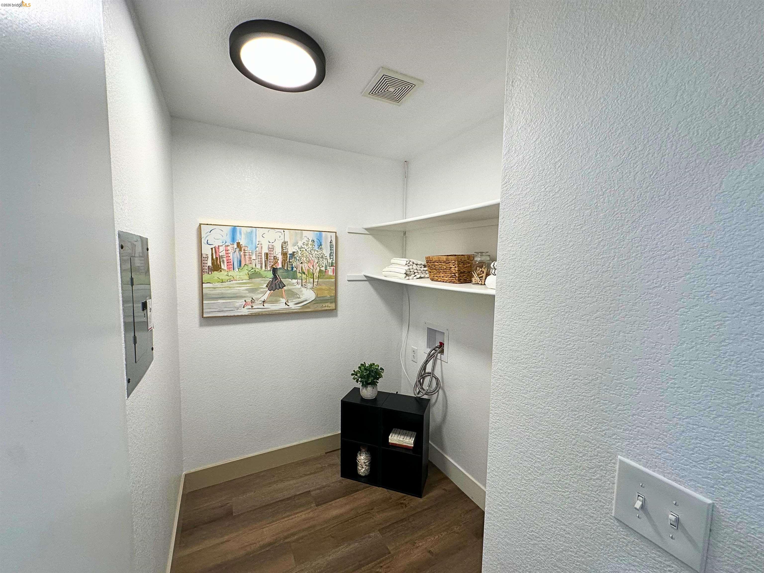 3075 Shiles Loop Brentwood, CA 94513 - Photo 8 of 37 Hall featuring a textured wall, dark wood-style flooring, and electric panel