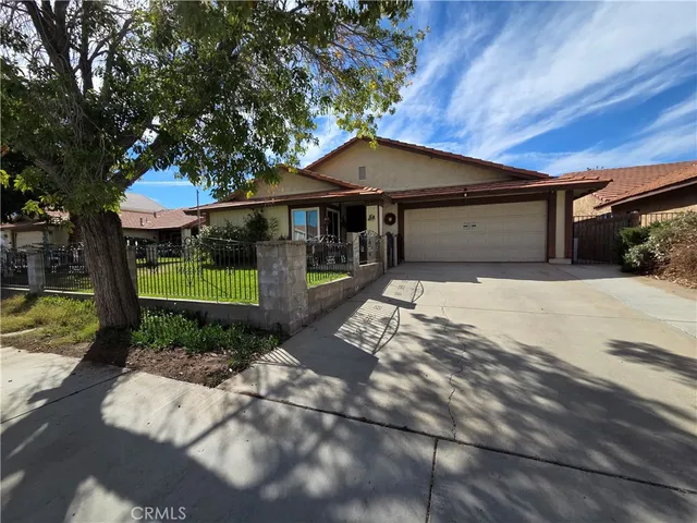 a front view of a house with a yard outdoor seating and garage