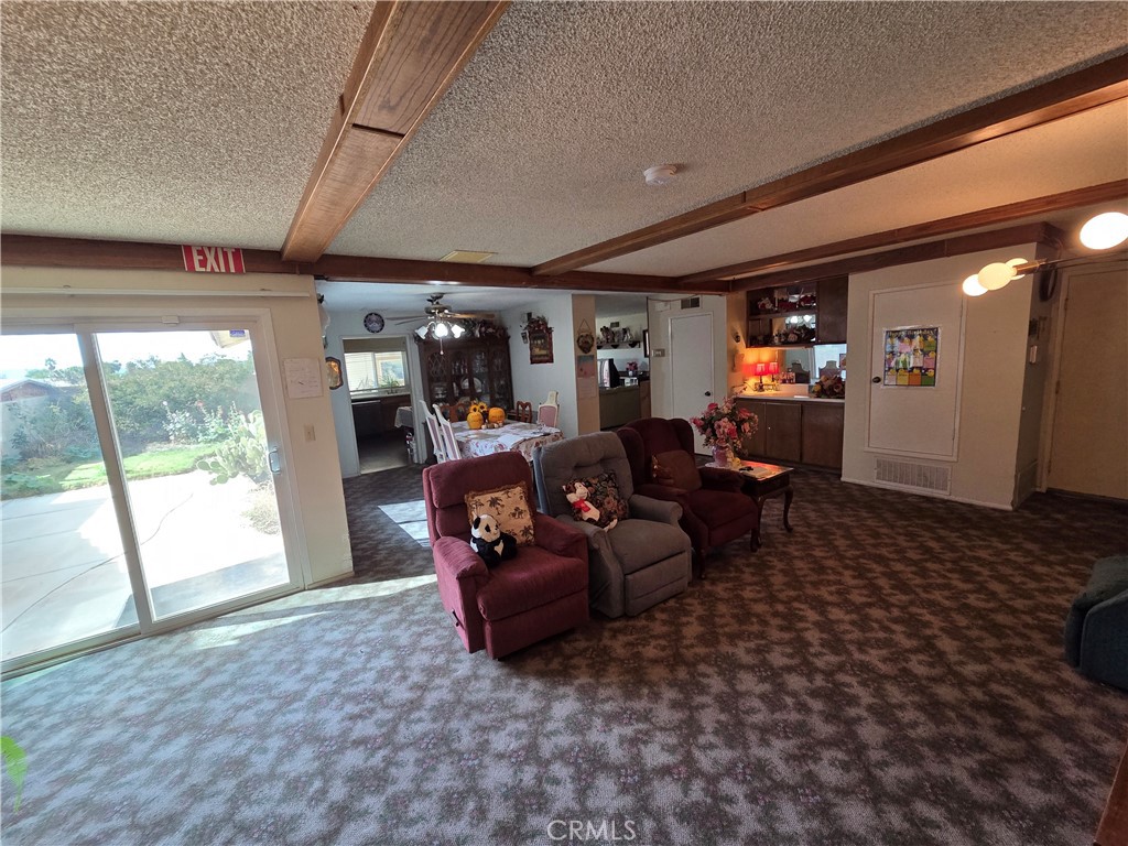 44047 Rodin Avenue Lancaster, CA 93535 - Photo 16 of 26 a living room with furniture and a flat screen tv