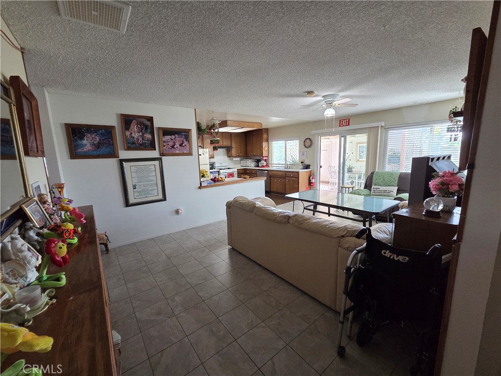 44047 Rodin Avenue Lancaster, CA 93535 - Photo 18 of 26 a living room with furniture and a flat screen tv