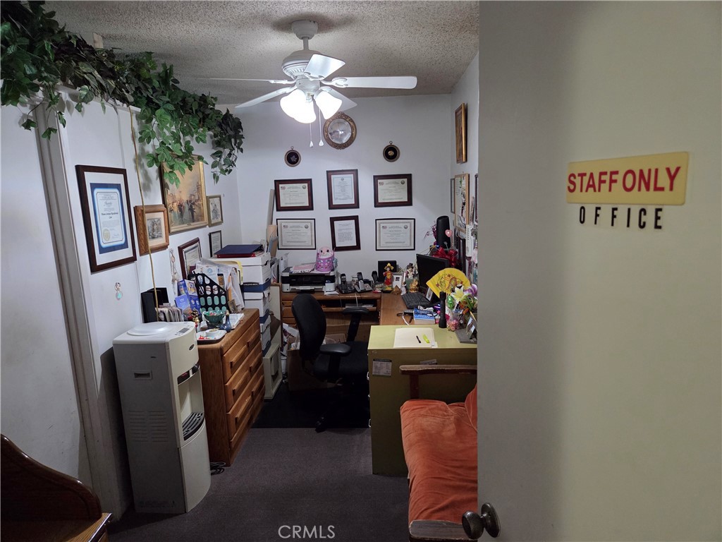 44047 Rodin Avenue Lancaster, CA 93535 - Photo 8 of 26 a view of a workspace with furniture and a chandelier