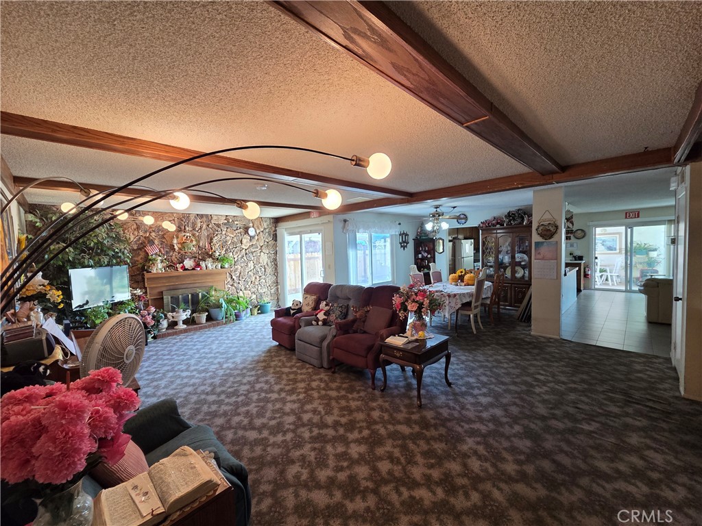 44047 Rodin Avenue Lancaster, CA 93535 - Photo 9 of 26 a living room with furniture and a large window