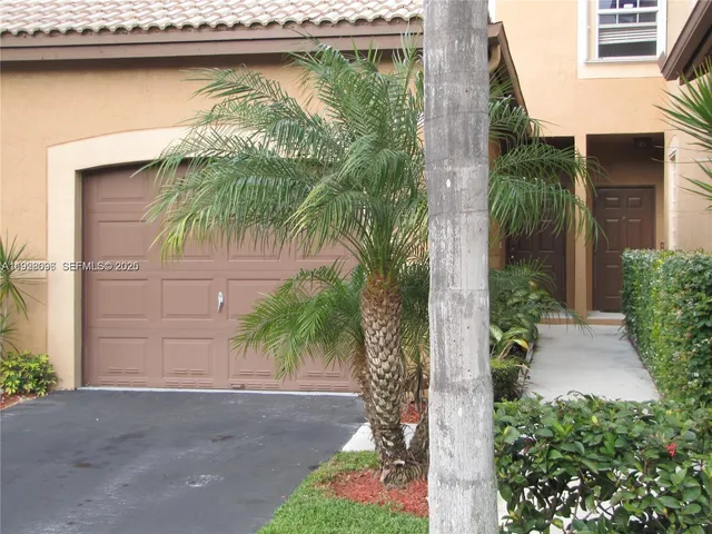 a couple of potted plants in front of door of house