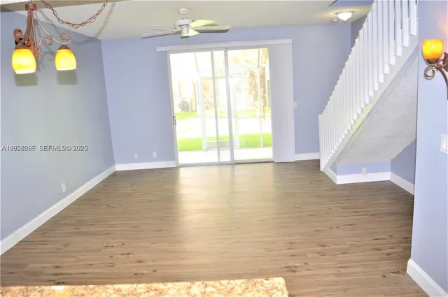 a view of a room with wooden floor and windows