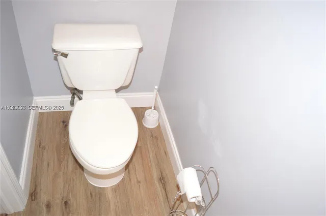 a bathroom with a toilet and a mirror