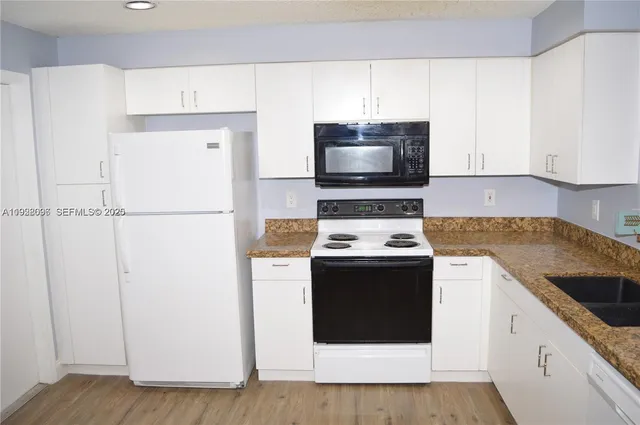 a kitchen with a stove and a refrigerator
