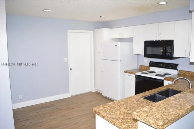 a kitchen with a appliances and a refrigerator
