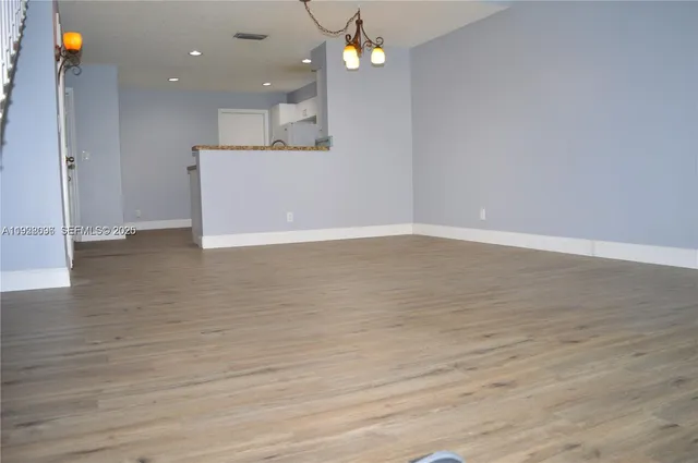 a view of a kitchen with a sink and a refrigerator