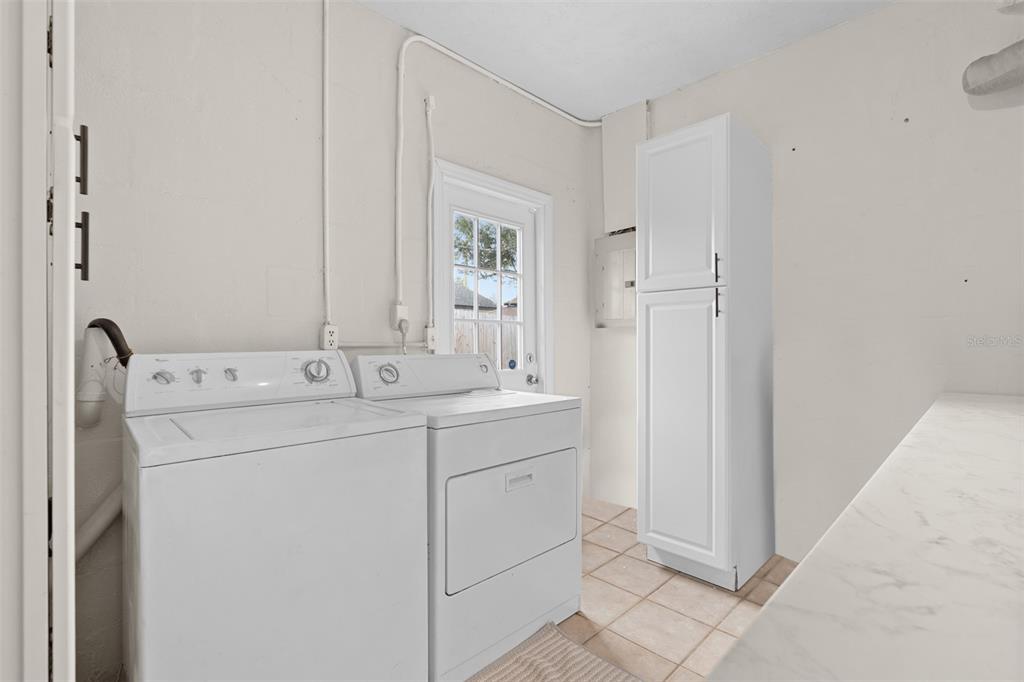 755 43rd Street St. Petersburg, FL 33713 - Photo 23 of 46 a utility room with cabinets washer and dryer
