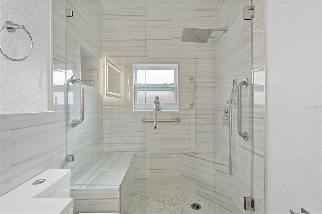 755 43rd Street St. Petersburg, FL 33713 - Photo 25 of 46 a bathroom with a shower and mirror