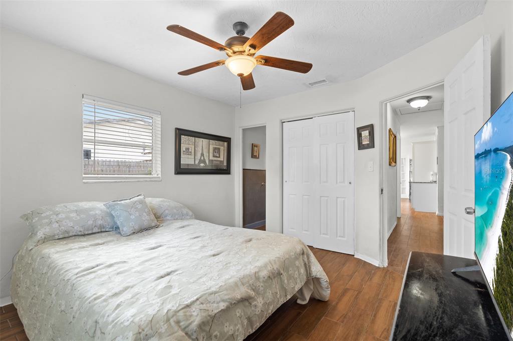 755 43rd Street St. Petersburg, FL 33713 - Photo 27 of 46 a bedroom with a large bed and a ceiling fan