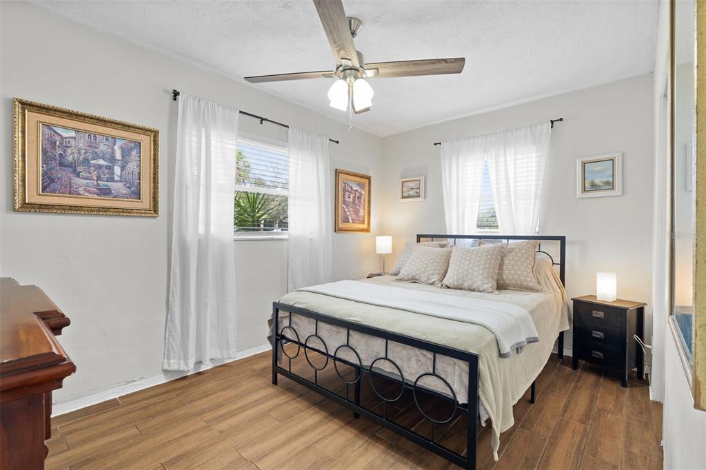 755 43rd Street St. Petersburg, FL 33713 - Photo 30 of 46 a bedroom with a bed a window and painting on the wall