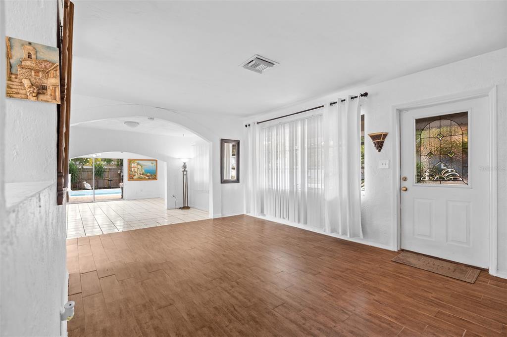 755 43rd Street St. Petersburg, FL 33713 - Photo 6 of 46 a view of an empty room with wooden floor and a window