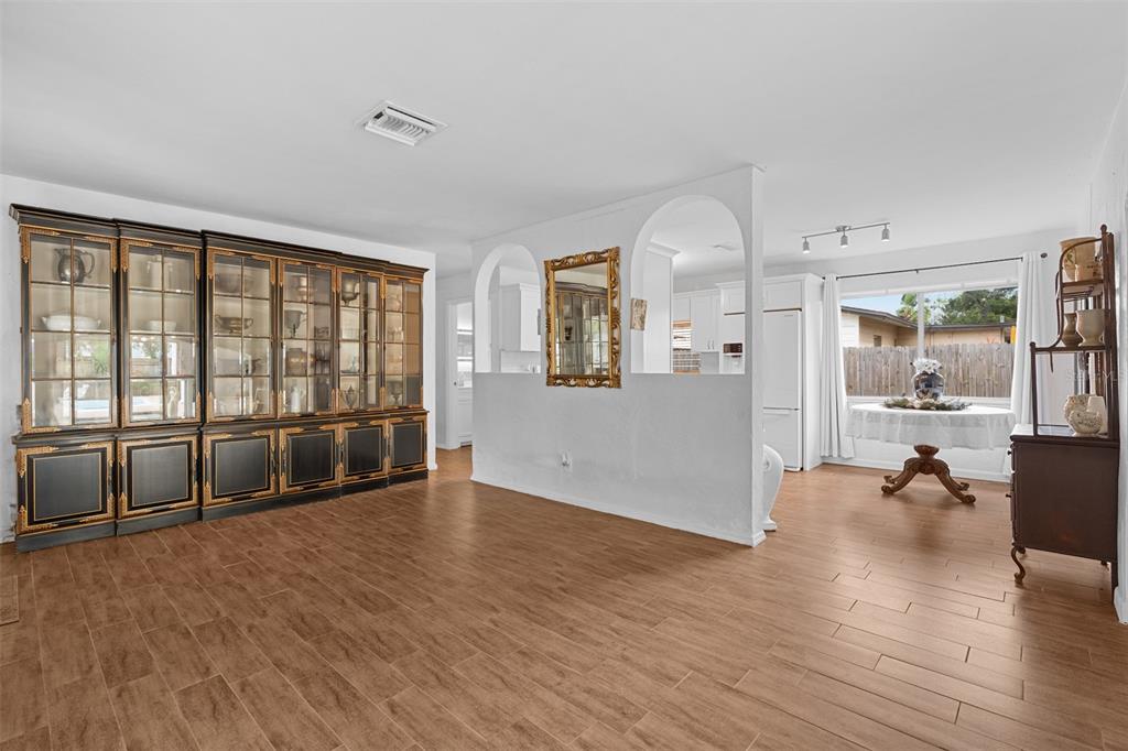 755 43rd Street St. Petersburg, FL 33713 - Photo 7 of 46 an empty room with wooden floor and windows