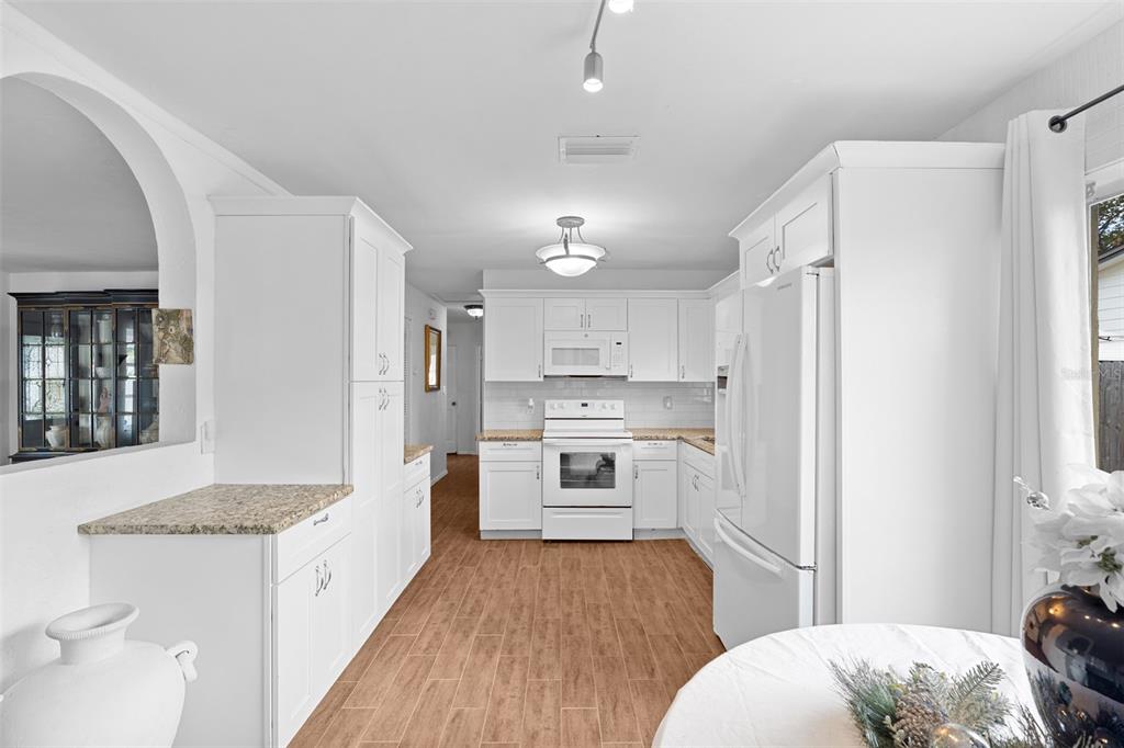 755 43rd Street St. Petersburg, FL 33713 - Photo 9 of 46 a open kitchen with white cabinets and stainless steel appliances