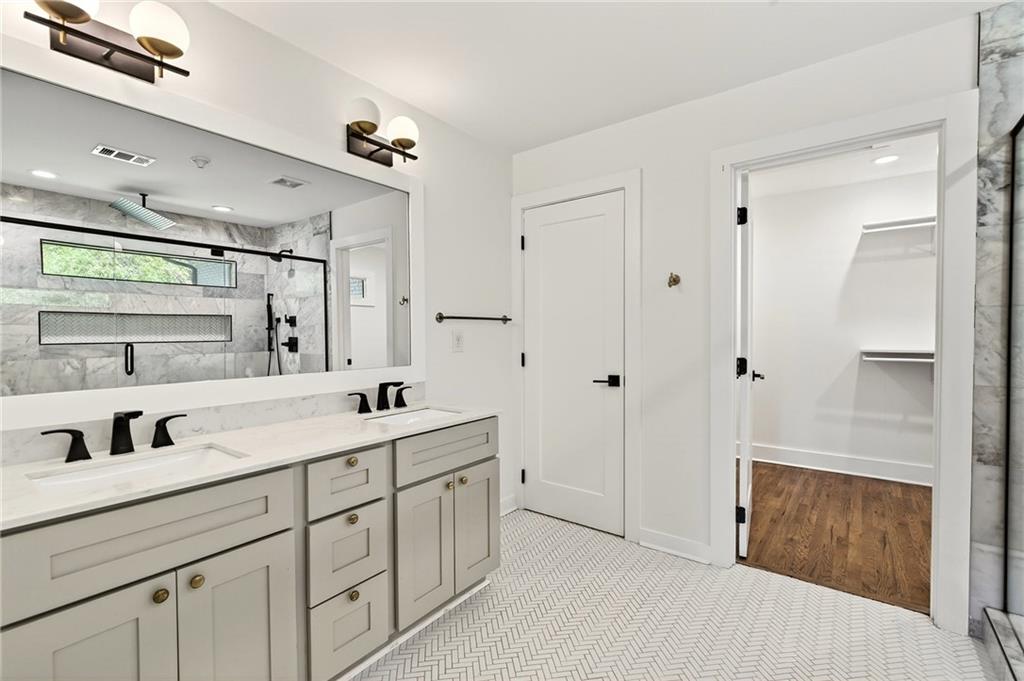 1344 Midlawn Drive Decatur, GA 30032 - Photo 55 of 87 a bathroom with a double vanity sink a mirror and a shower