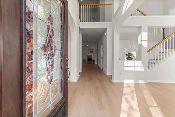 a view of an entryway with wooden floor