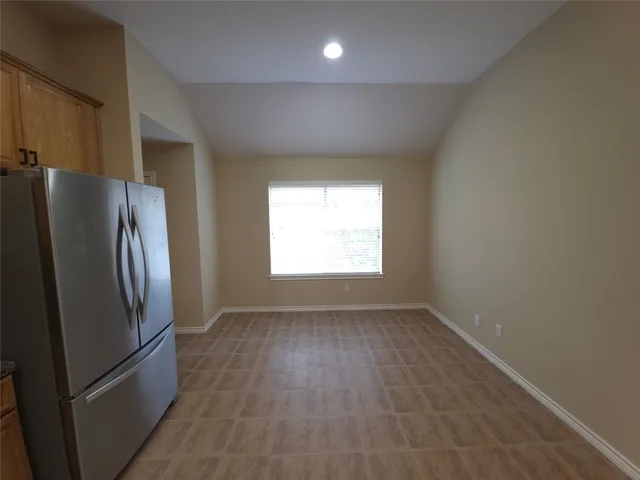 a view of a refrigerator in kitchen and wooden floor