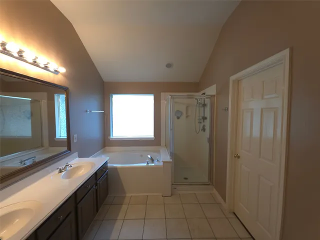 a bathroom with a sink mirror and a bathtub